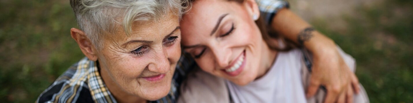 Older woman embracing a younger woman