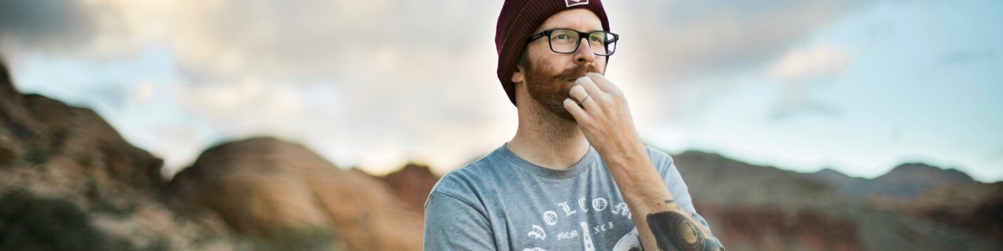 Man in a beanie looking thoughtful