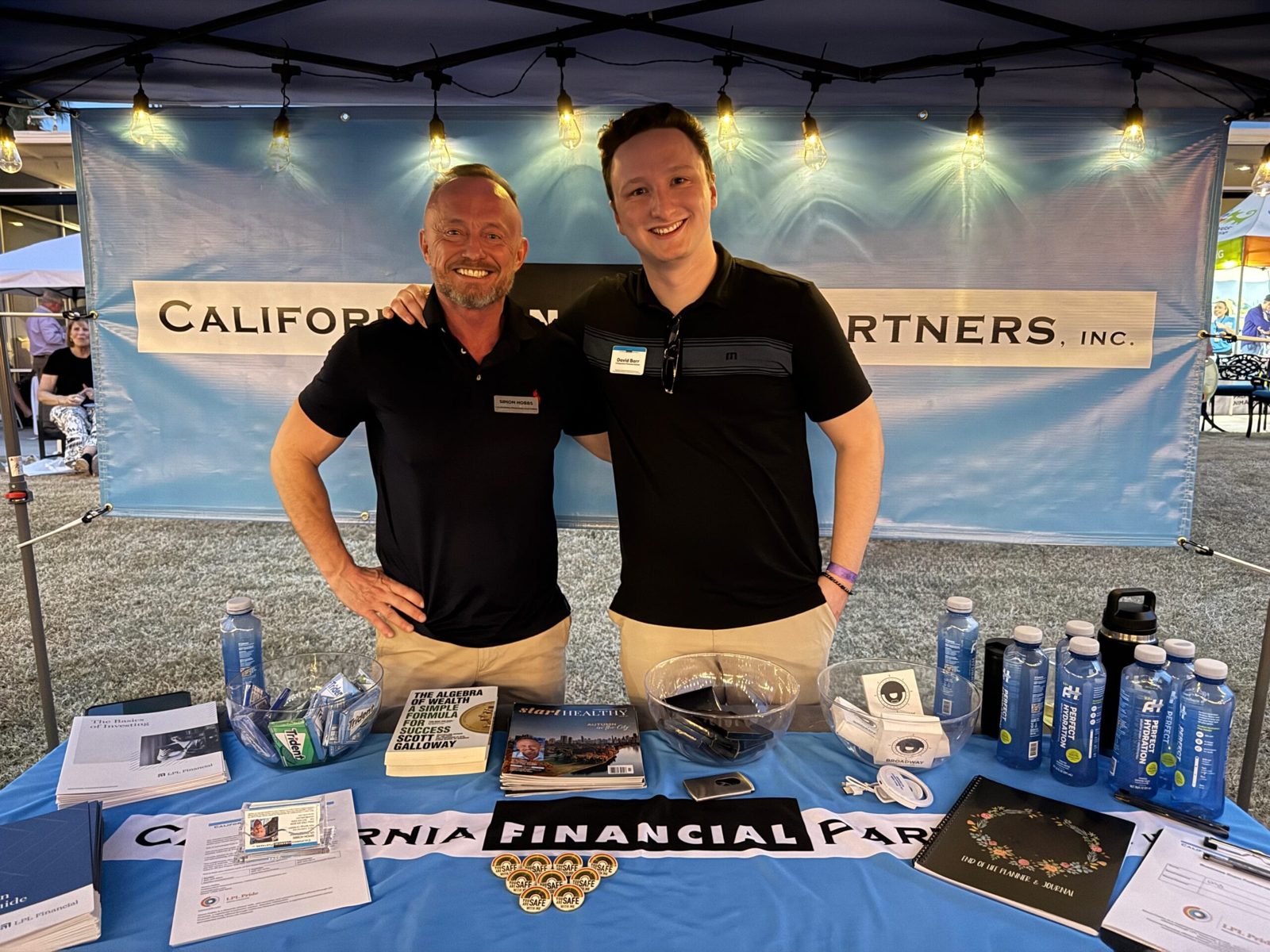 Simon Hobbs and a colleague at the California Financial Partners booth